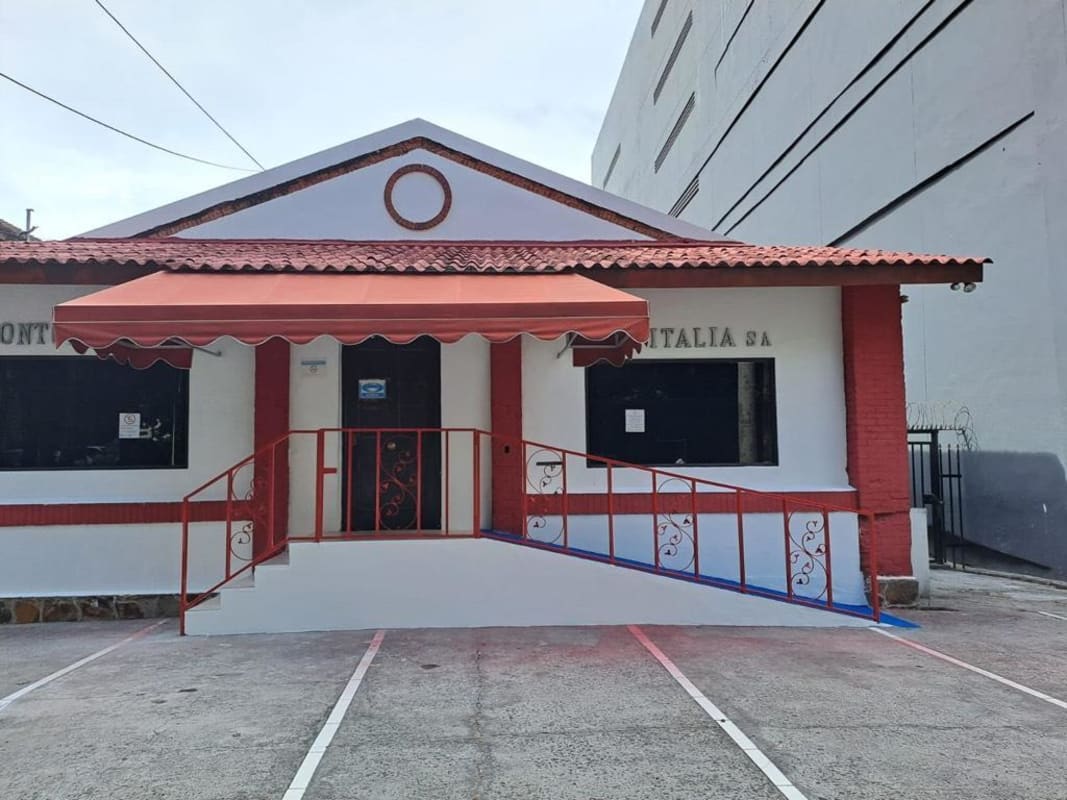 Entrance with blue handicap ramp and red tiles fronting Calle 51 Bella Vista Panama