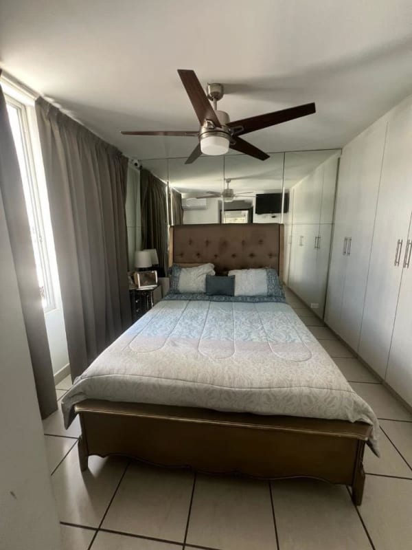 Primary bedroom with mirrored closet, AC, ceilings fan, in PH Lefevre 75 apartment Panama