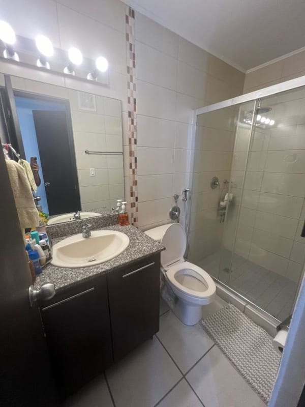 Bathroom featuring granite counter, glass shower enclosure mosaic accent in PH Lefevre 75 Panama