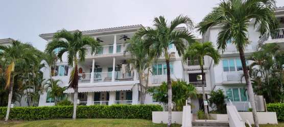 Mediterranean-style condo building with balconies, palm trees at Bijao Beach Resort Panama