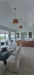 Dining area with glass table, large windows, open concept living at Bijao Beach Resort Panama