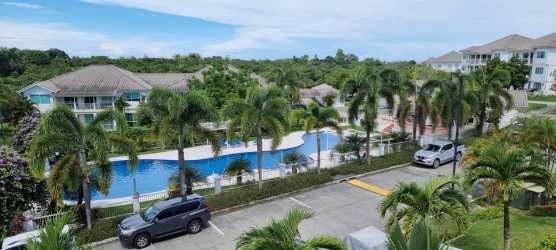 Resort-style community with palm trees, swimming pool and gardens at Bijao Panama