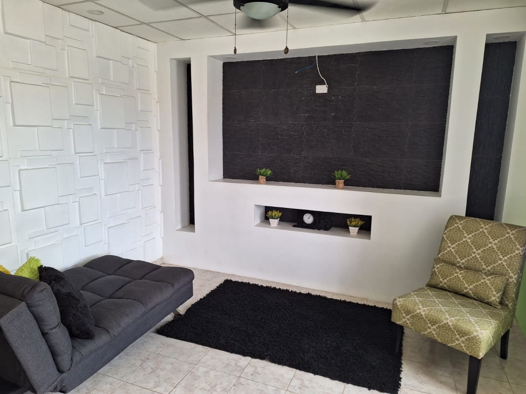 Bedroom with built-in closet and ceiling fan in Tocumen house for sale Panama City