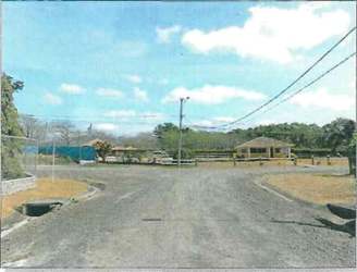 Entrance dirt road and fencing to Quebradas de Cabuya development in countryside Panama