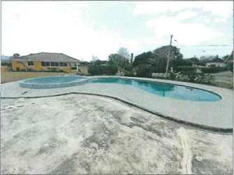View of the outdoor resident swimming pool and clubhouse within Quebradas de Cabuya Chame