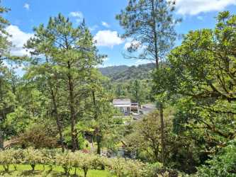 Balcony overlooking lush forest and mountain valley of private estate Altos del María