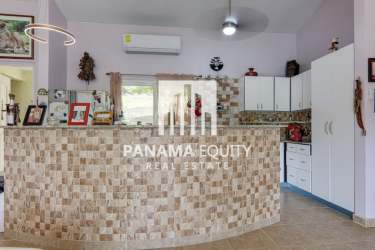 Kitchen featuring granite counters, breakfast bar, modern cabinets at Trinity Hills custom home Capira Panama