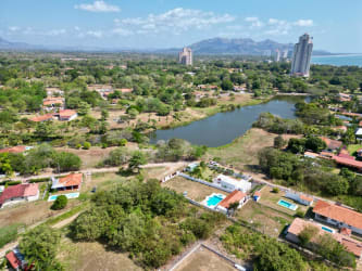 Lake view lot with open grassy space for building inside Coronado residential community Panama