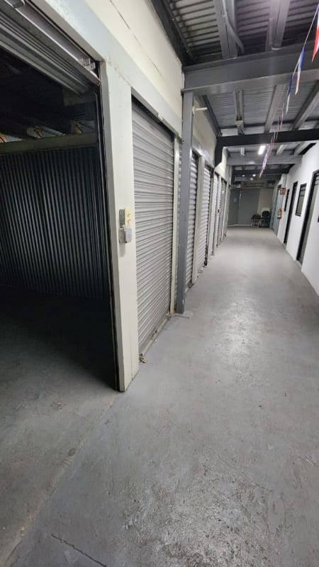 Interior of warehouse with storage units and roll-up metal doors at Rio Abajo Panama