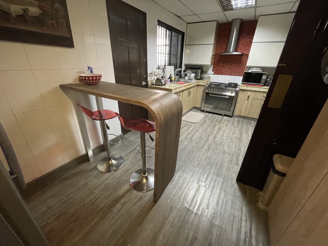 Contemporary kitchen with granite counters and wooden cabinetry Panama City