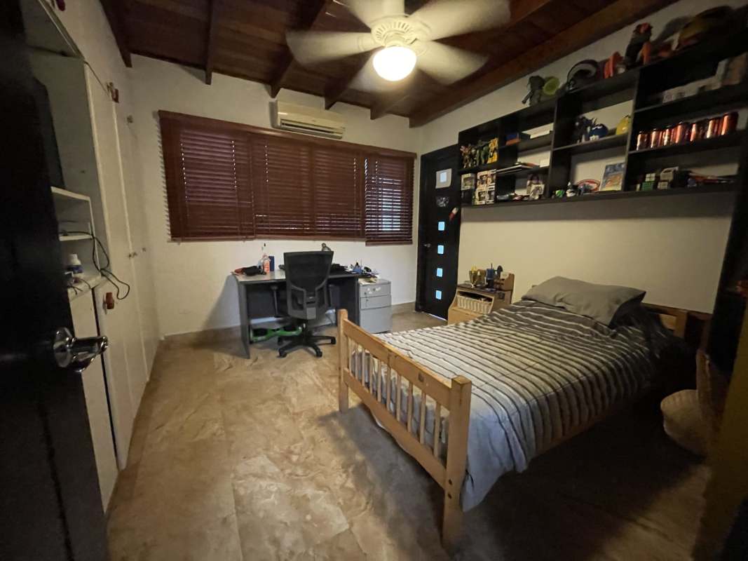 Ample covered terrace overlooking lush garden in luxury corner home Altos del Golf San Francisco Panama