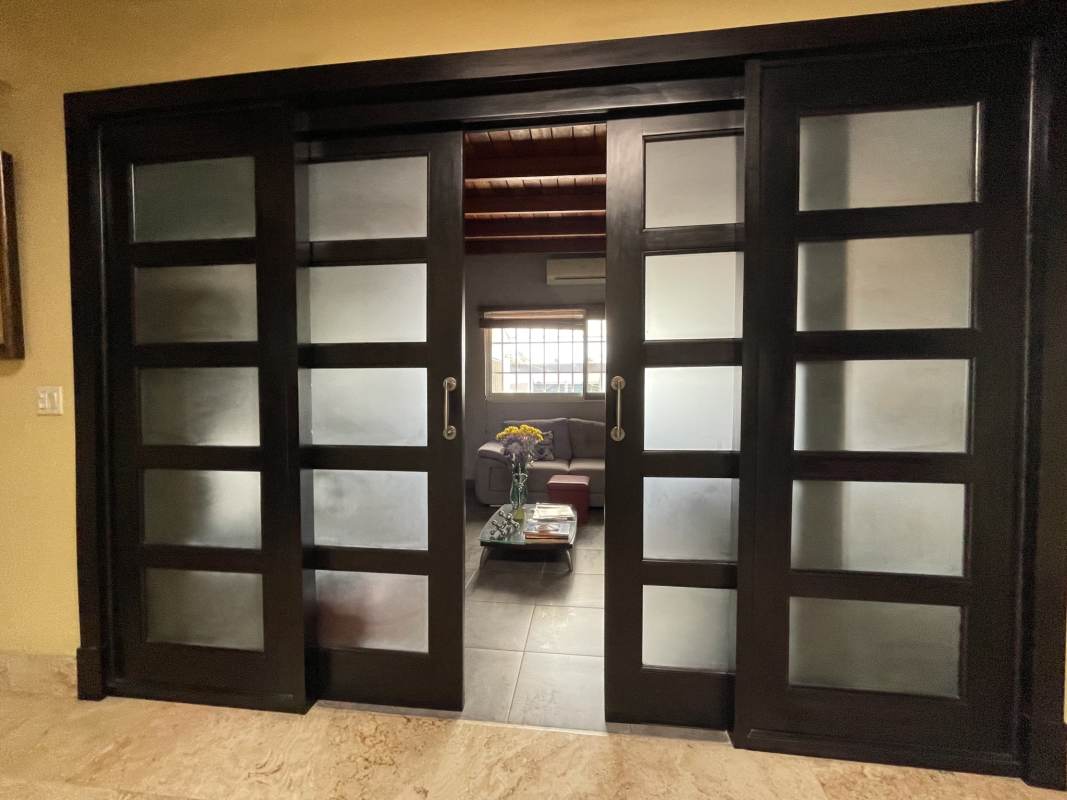 Luxury home kitchen granite island wooden cabinets vaulted beam ceiling in San Francisco Panama