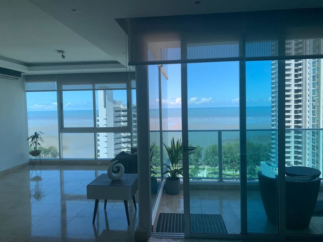 Modern living space with textured 3D accent wall, sectional sofa and marble floor at PH Titanium Panama