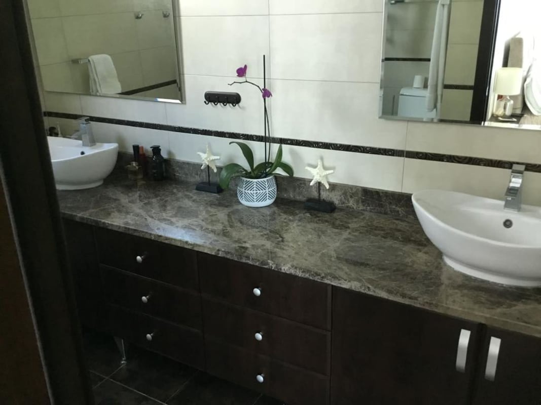 Large bedroom with ocean view windows, walk-in closet and ensuite bathroom in PH Titanium Panama