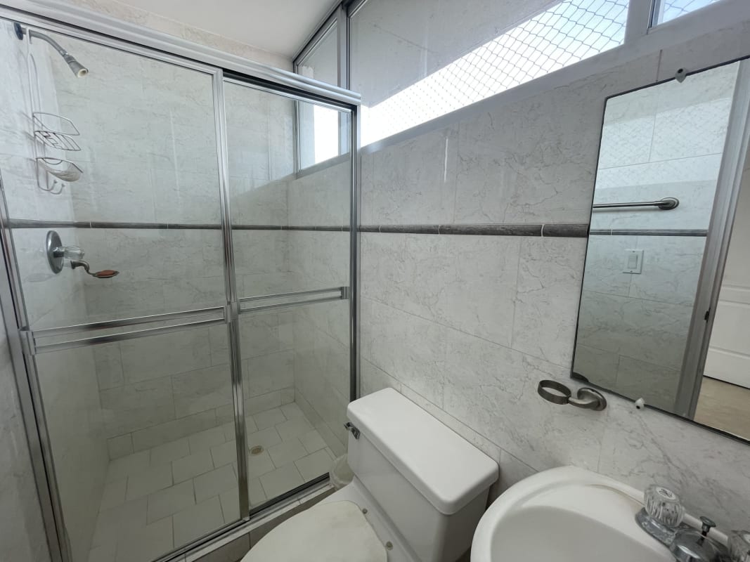 Bedroom featuring large windows overlooking the bay with balcony access in PH South Beach Panama