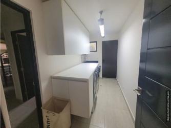 Modern laundry room with cabinets, washer area and countertop PH Nativa Panama