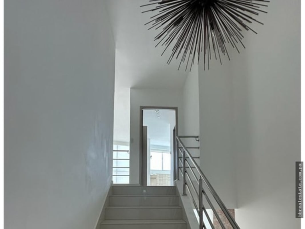 Stairwell with chandelier tall windows PH Park Loft San Francisco Panama
