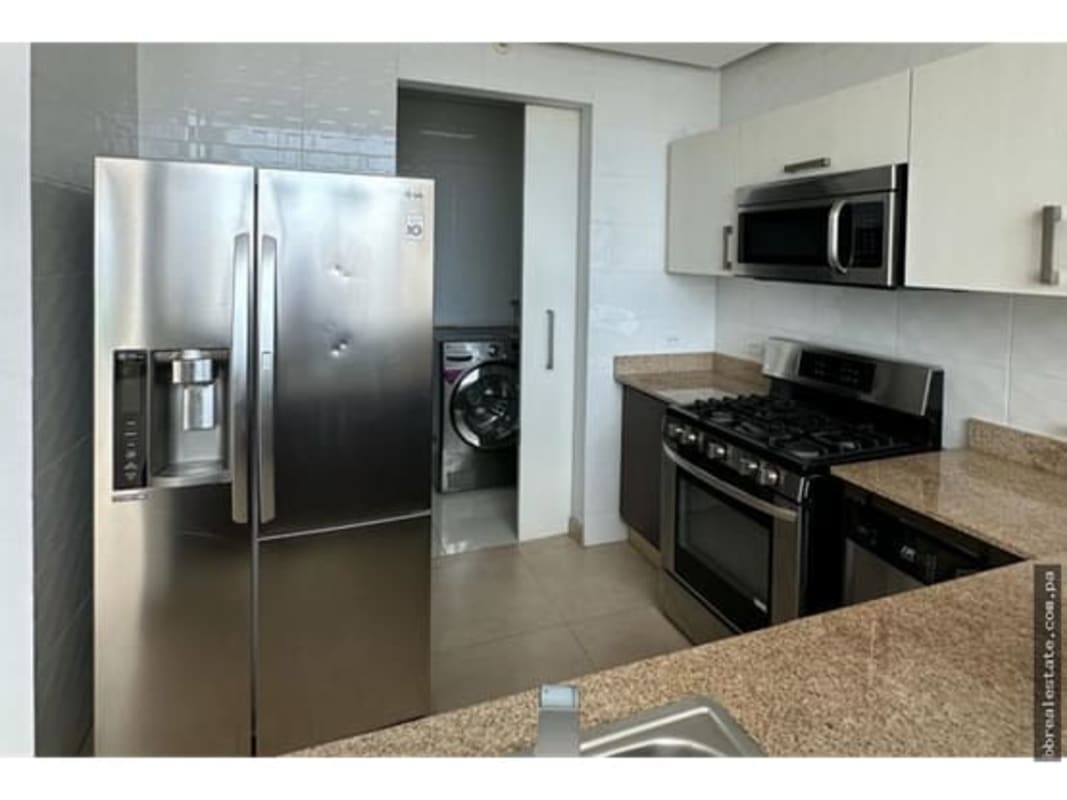 Kitchen with stainless appliances attached laundry PH Park Loft Panama