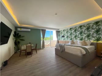 Studio bedroom with tropical wallpaper, king bed, balcony view Playa Blanca Panama
