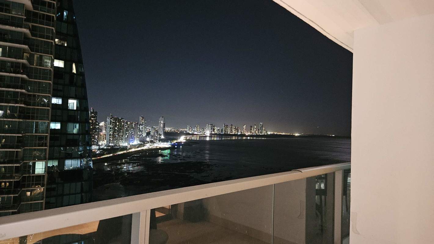 Modern balcony with glass railing showcasing oceanfront and skyline views from PH TOC Punta Pacifica Panama City