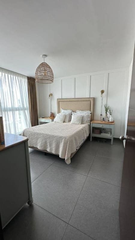 Modern bedroom with mounted TV, AC, and coastal design Kings Park Tower 200 Panama City