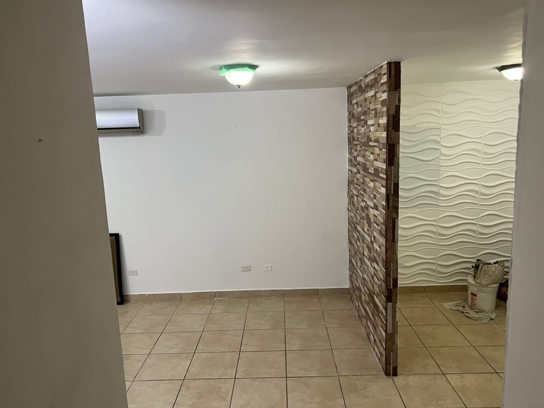 Open living room with accent wall and AC PH Alpes Brisas del Golf Panama