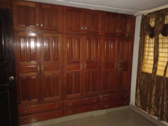 Bedroom with large wooden wardrobe in commercial house La Villa Panama