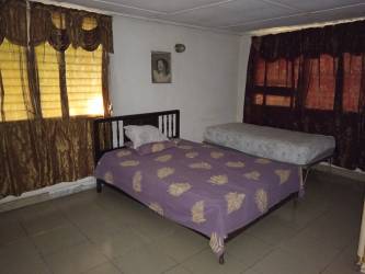 Bedroom with two beds in affordable mixed-use house La Villa de Los Santos