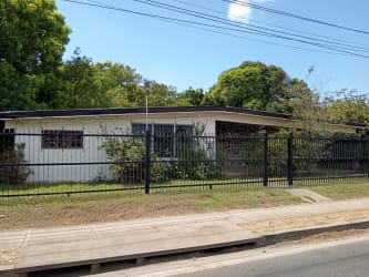 Covered entry with stone accent wall and tiled floor at commercial house La Villa de Los Santos