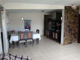 Dining room with tile flooring and stone accent in commercial home Panama