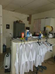 Laundry room with overhead cabinets, laundry hookup, and ample space in Las Tablas house