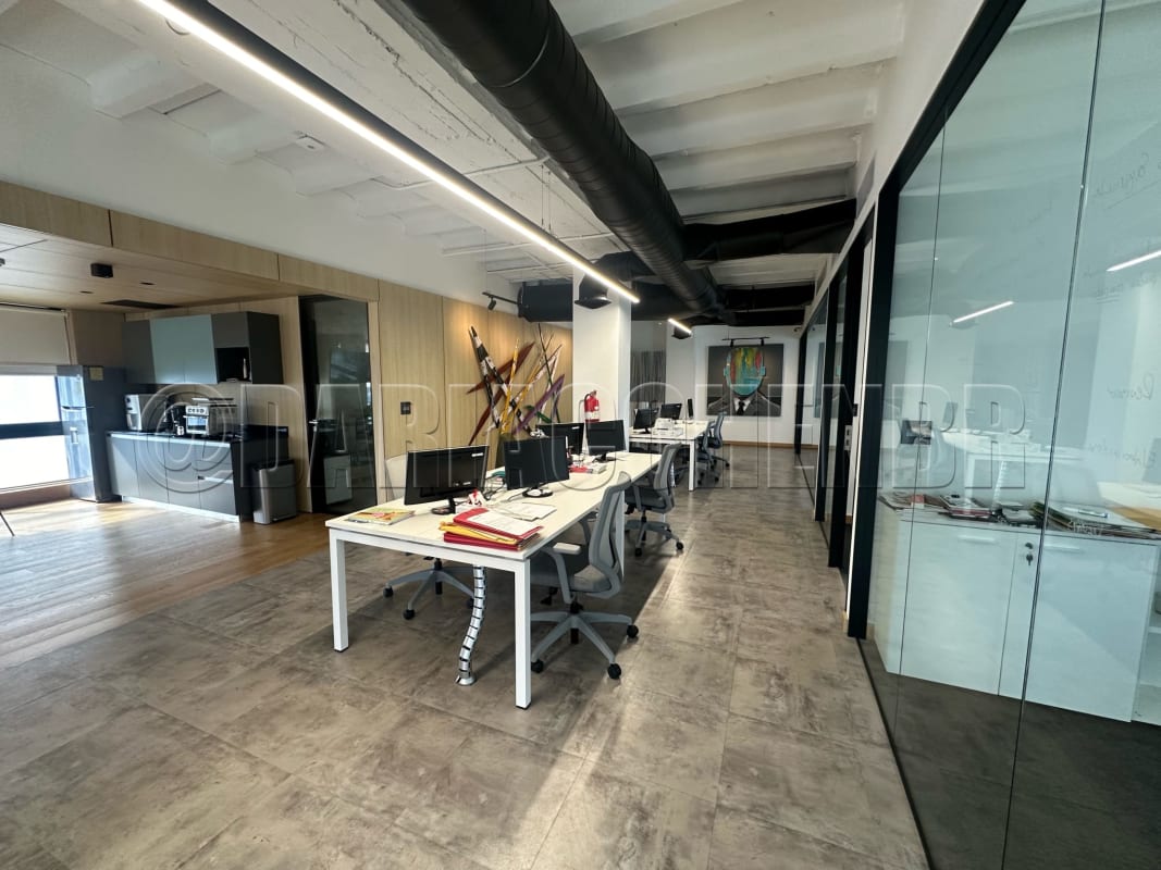 Office workspace open-plan glass partitions kitchenette exposed ceiling in Obarrio Panama