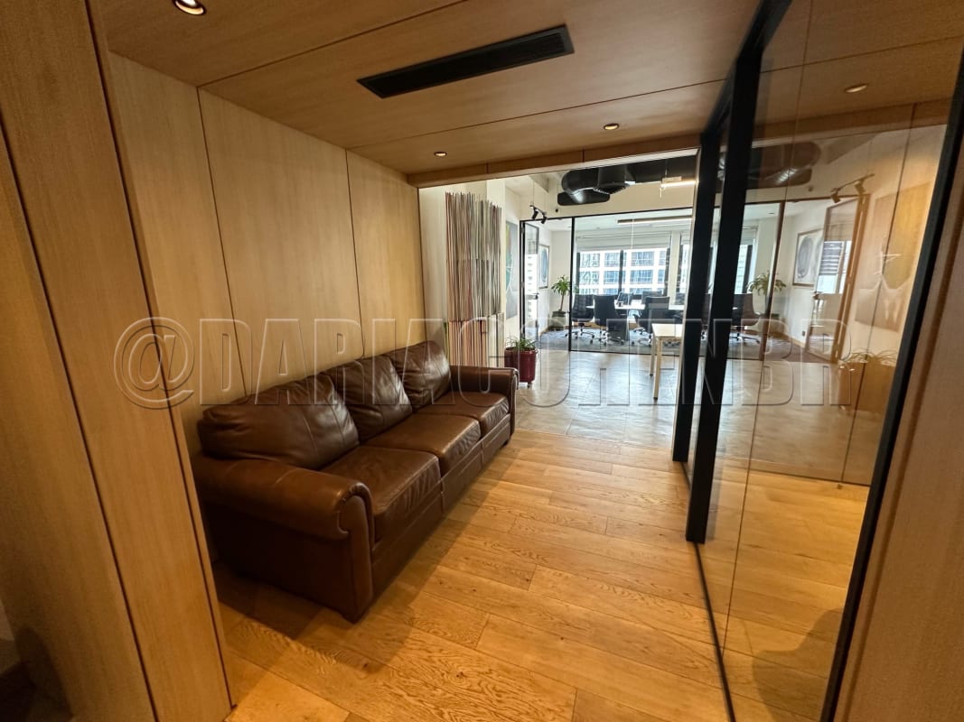 Lounge area with blue chairs wooden walls pendant lighting inside office tower Plaza 2000 Panama