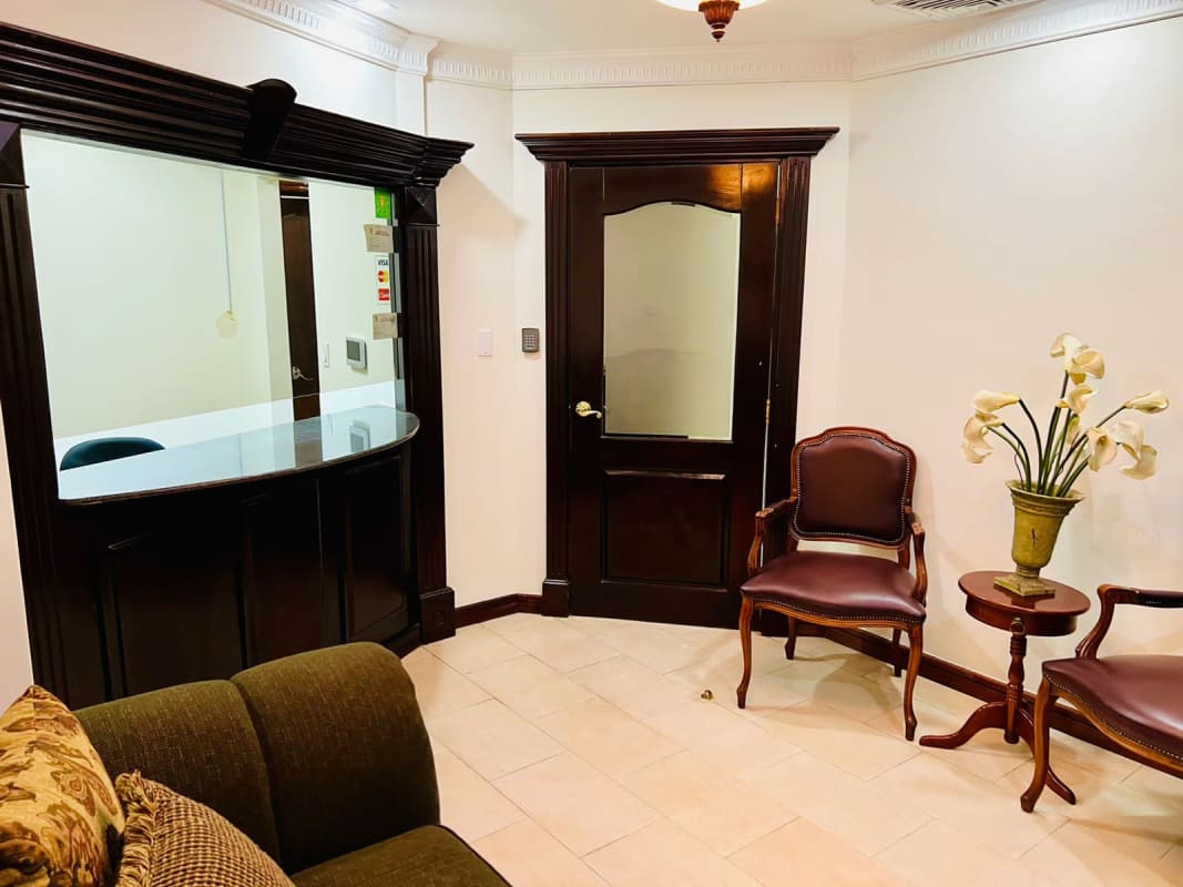 Spacious conference room with wooden table and leather chairs at PH Omega Office Tower Obarrio Panama