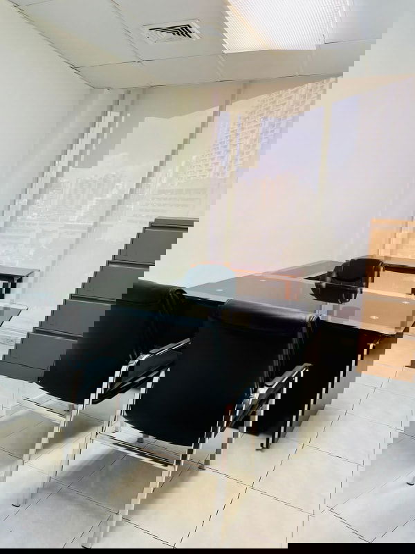 Glass-top office desk with chairs large windows PH Omega Panama