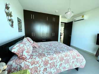 Modern bedroom with ocean view window at PH Founders Playa Blanca Panama