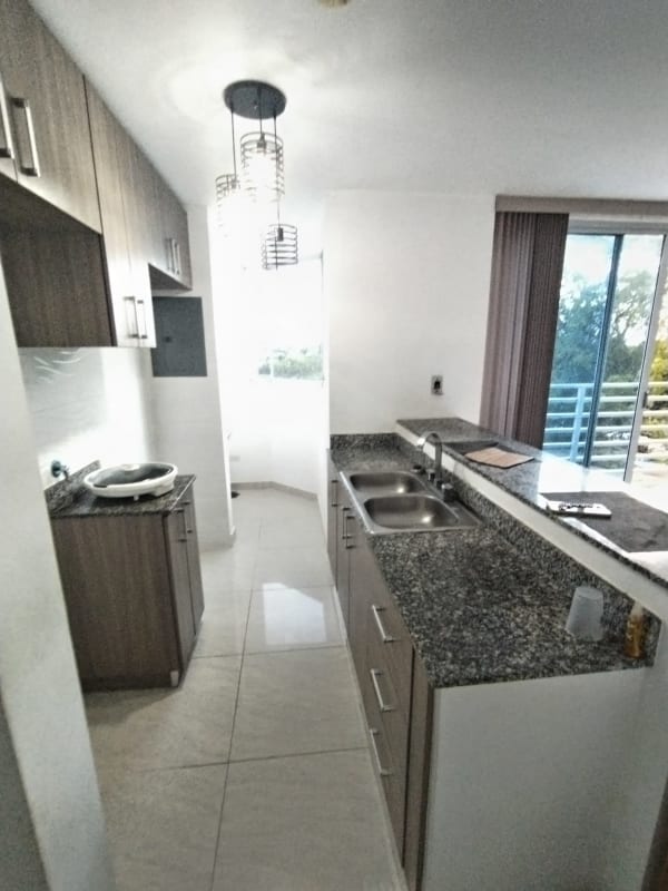 Open kitchen with granite countertops and breakfast bar in PH Terrazas de Balmoral Pedregal Panama City