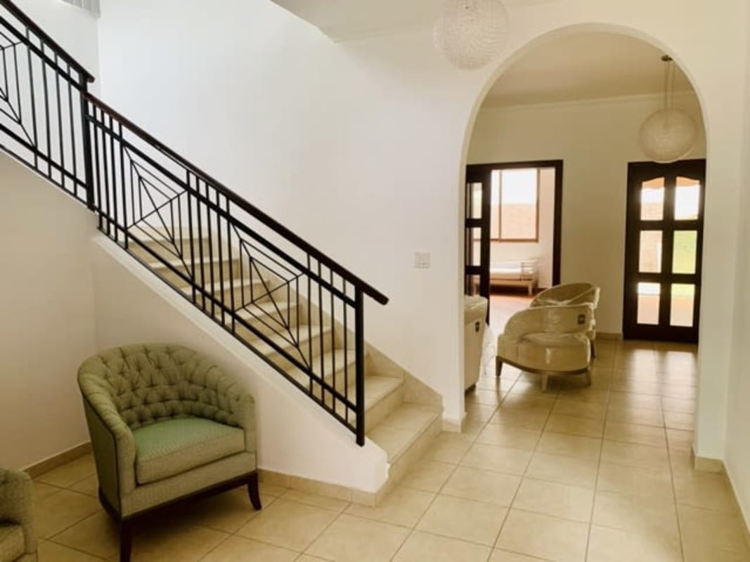 Large airy living and dining area ceramic flooring arched doorway garden views Camino de Cruces Panama City