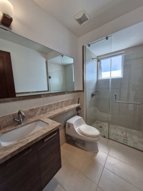 Modern open dining and living room with marble floors and balcony at The Reserve Santa María