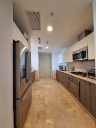 Bright bedroom with two beds, blue walls, ceiling fan at Puntarena Buenaventura resort condo Panama