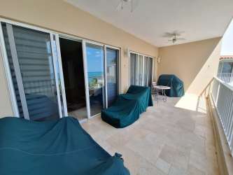 Bedroom with large sliding glass doors, terrace access and ocean views in luxury beach condo Puntarena Panama