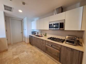 Spacious covered balcony with patio furniture and ceiling fans overlooking ocean in Puntarena Buenaventura Panama