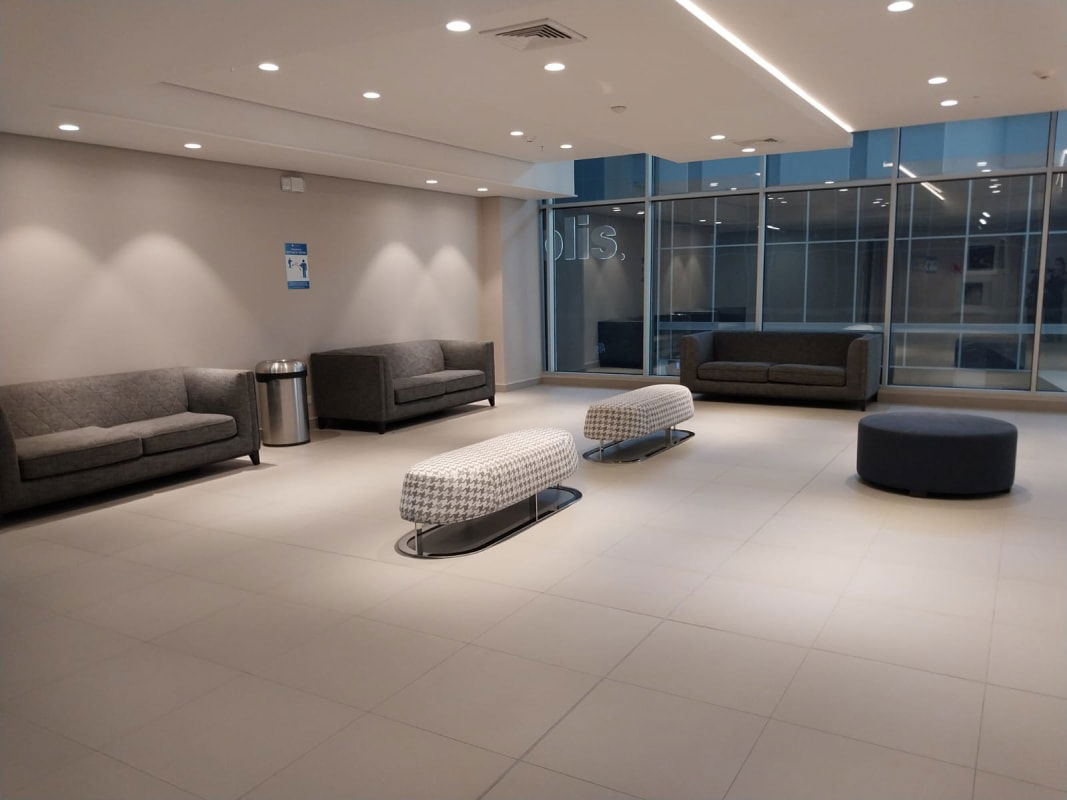 Modern mall lobby lounge glass windows seating grey sofas Town Center Costa del Este