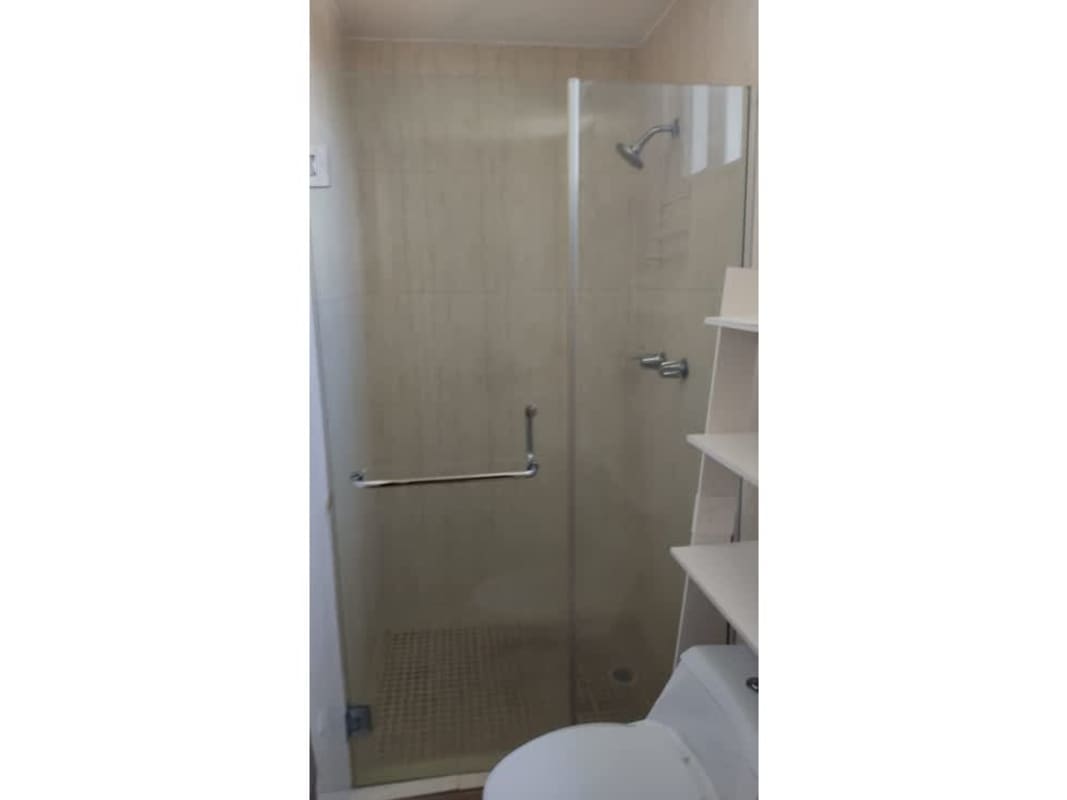 Bathroom with glass shower, tiled walls at PH Terrazas del Rey Condado del Rey Panama