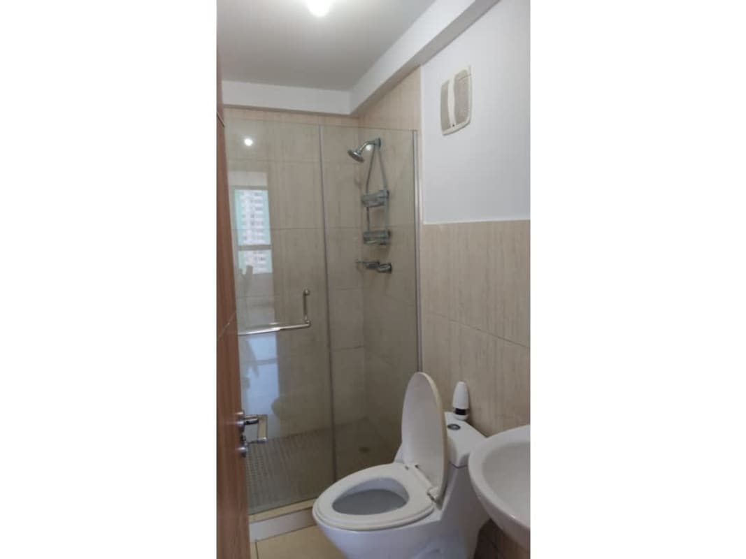 Bathroom with glass shower enclosure, pedestal sink, and tiles PH Terrazas del Rey Panama