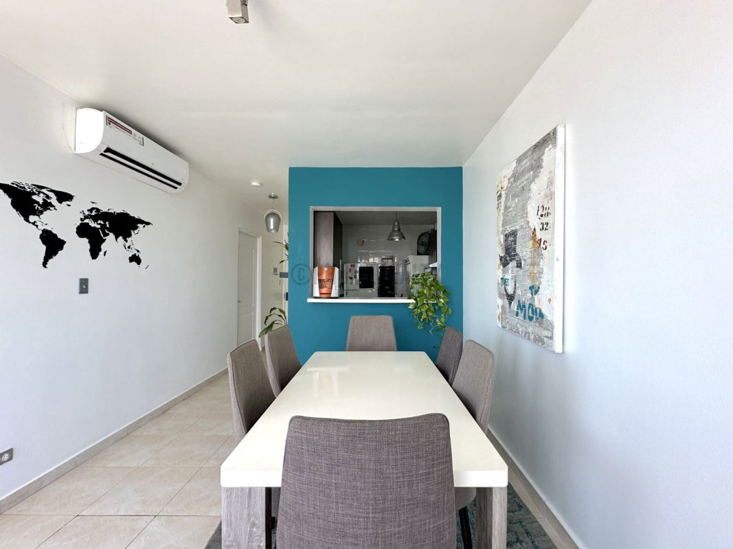 Kitchen with quartz countertops, cabinets, and pass-through window at Edison Park Tower