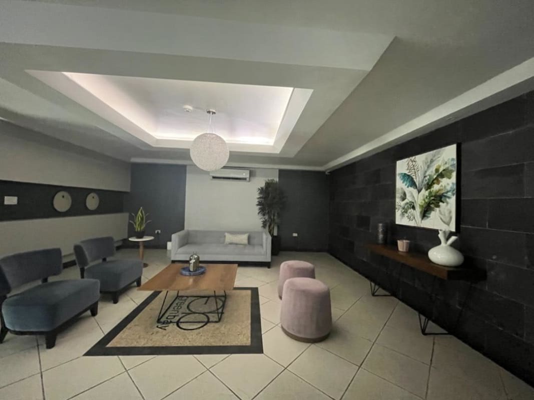 Bright living room connected to balcony with large tile flooring and city views in PH Green Bay Costa del Este Panama