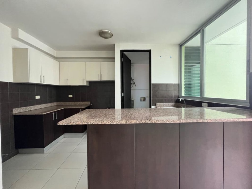 Modern bathroom with glass shower enclosure and granite sink countertop in PH Green Bay Costa del Este Panama