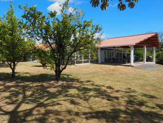 Covered terrace outdoor patio with garden views lush yard Cabuya beachside house