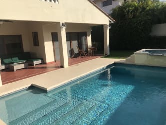 Covered outdoor patio with dining set and BBQ grill Coronado Panama beach villa